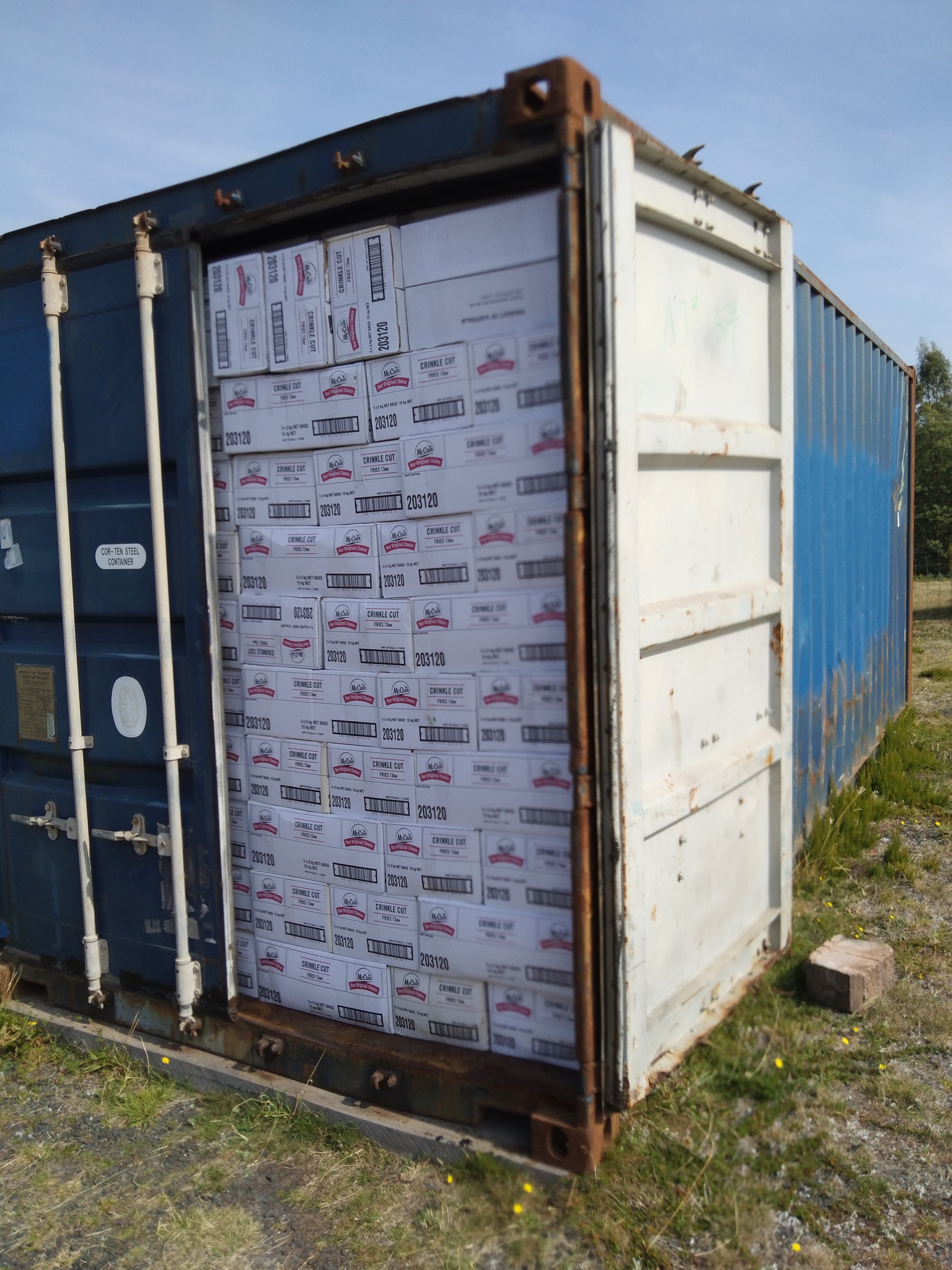 A tall, white shipping container.