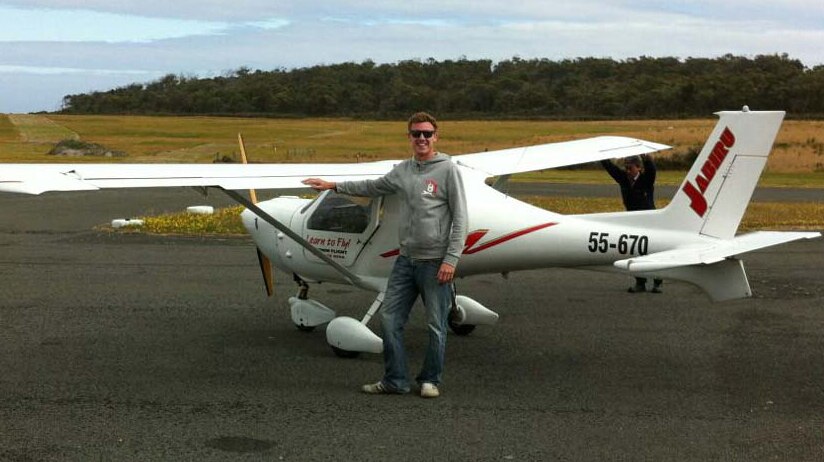 Newcastle pilot Shayd Hector stands in front an ultralight plane owned by instructor Eugene Reid.