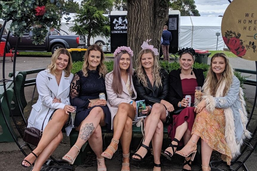 A group of women dressed up for the races