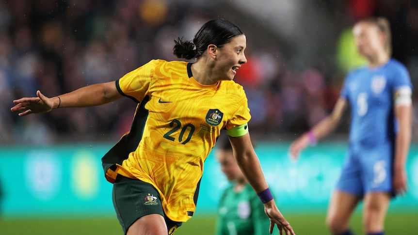 Sam Kerr smiles as she runs away after scoring a goal for the Matildas against England.