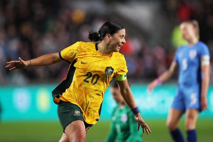 Sam Kerr smiles as she runs away after scoring a goal for the Matildas against England.