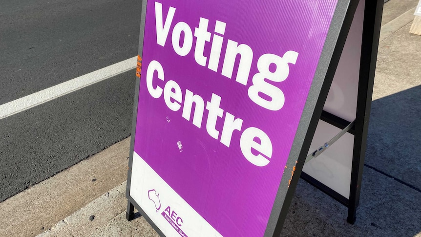 a sign with 'voting centre' in purple and white