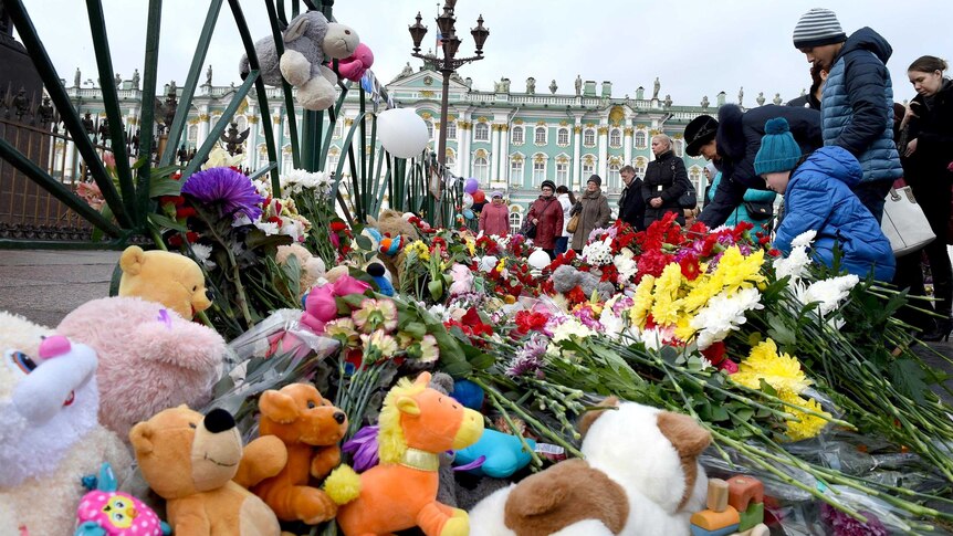 People place flowers at Dvortsovaya Square in St Petersburg in memory of the victims of Kogalymavia Airlines flight 9268.