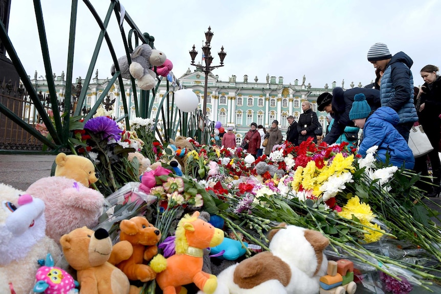 People place flowers at Dvortsovaya Square in St Petersburg in memory of the victims of Kogalymavia Airlines flight 9268.