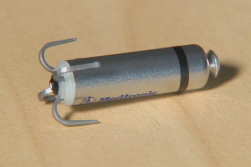 A bullet-shaped object with hooks at one end.