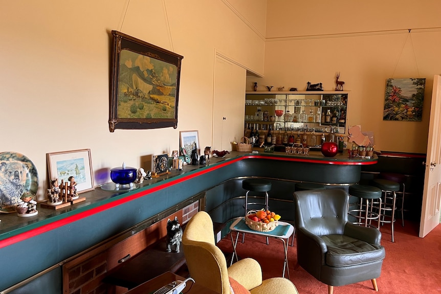 A cluttered mantle and bar in an historic home with remnants of the past.