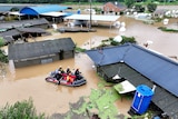 Rescue workers take part in a rescue operation at a town submerged by typhoon Khanun in Daegu.
