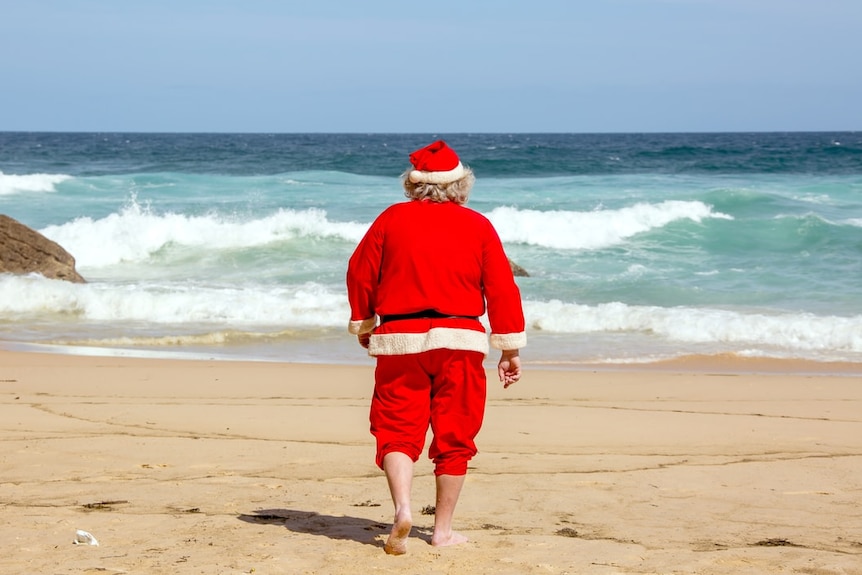 Father Christmas walking out to have a swim