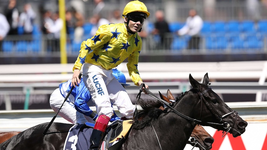 Jamie Spencer rides Side Glance to victory in the Mackinnon Stakes at Flemington.
