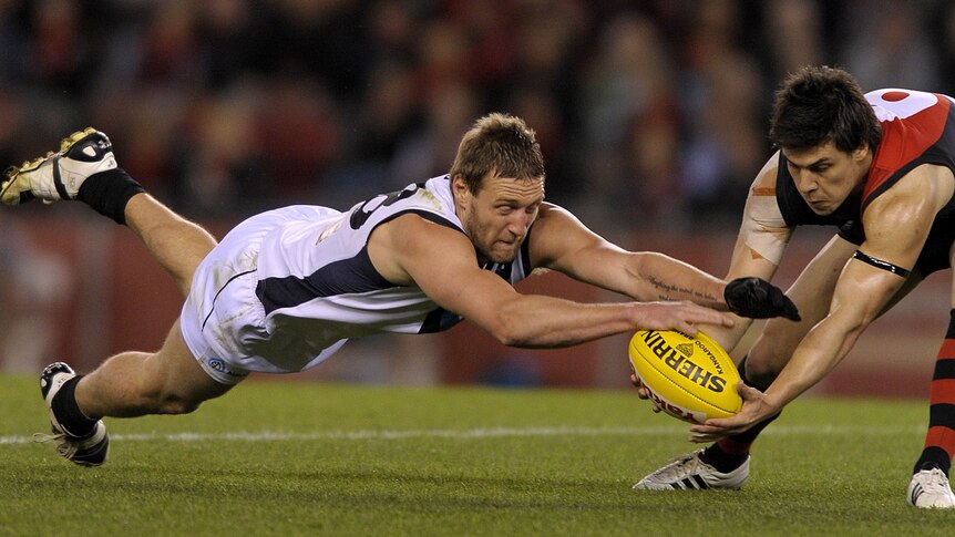 Angus Monfries keeps the ball away from Jay Schulz as the Bombers snatch victory from Port.
