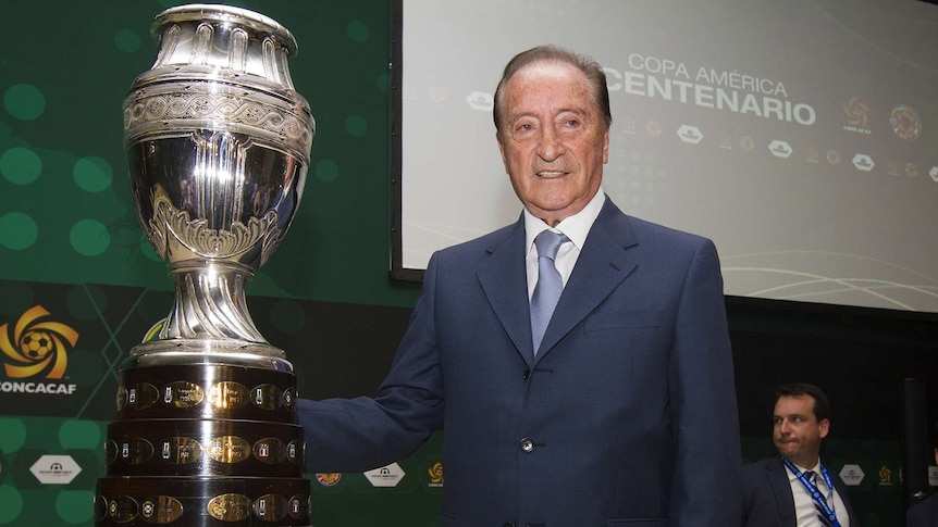 CONMEBOL president Eugenio Figueredo poses with the Copa America trophy.