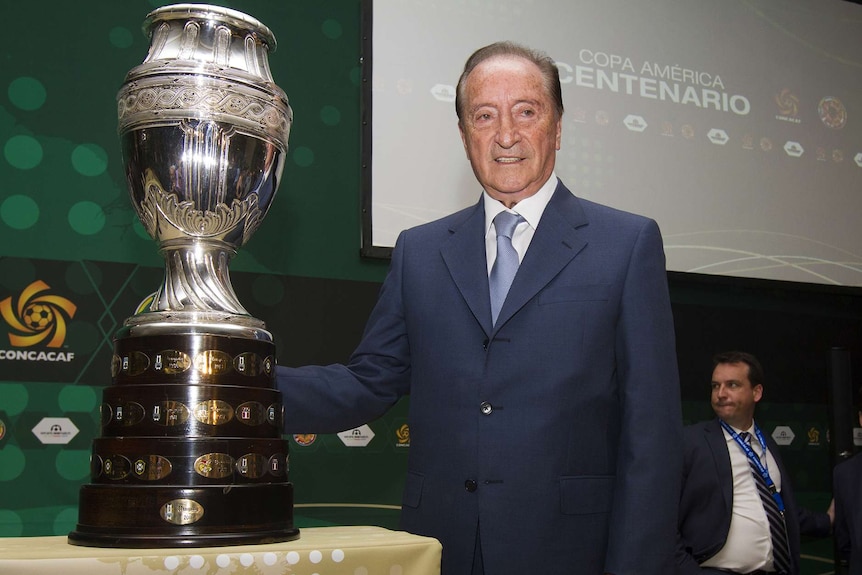 CONMEBOL president Eugenio Figueredo poses with the Copa America trophy