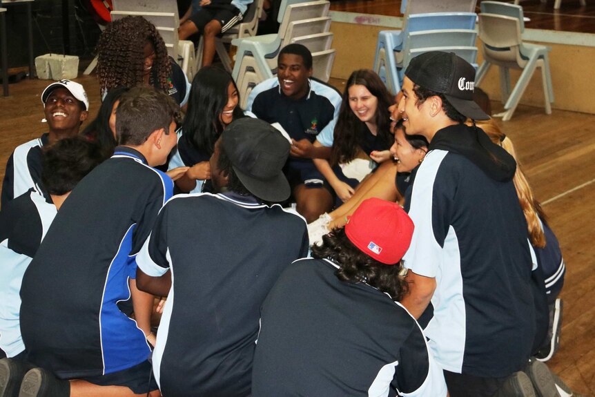 A group of Balga Senior High School students laughing during a theatre workshop.