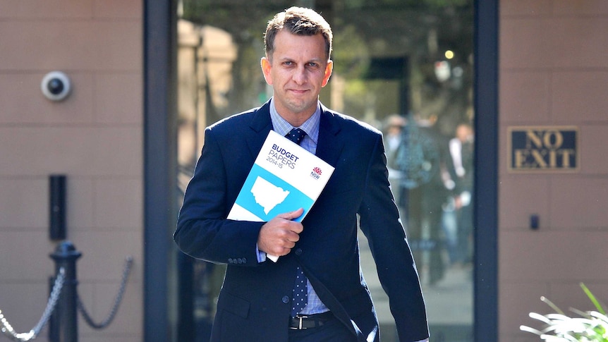NSW Treasurer Andrew Constance arrives with the budget papers at Parliament House in Sydney.