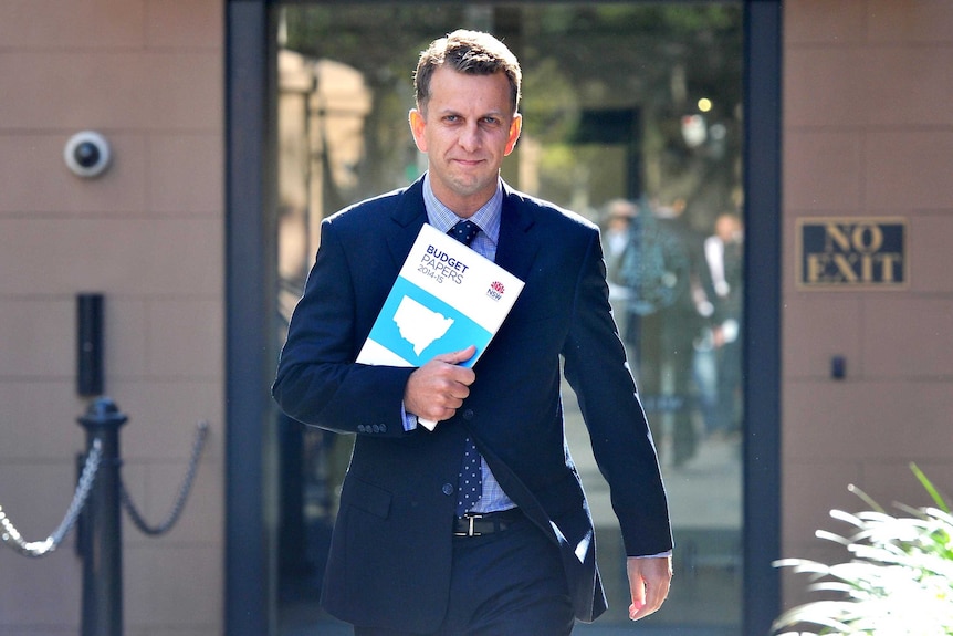 NSW Treasurer and Bega MP Andrew Constance arrives with the budget papers at Parliament House in Sydney on Tuesday.