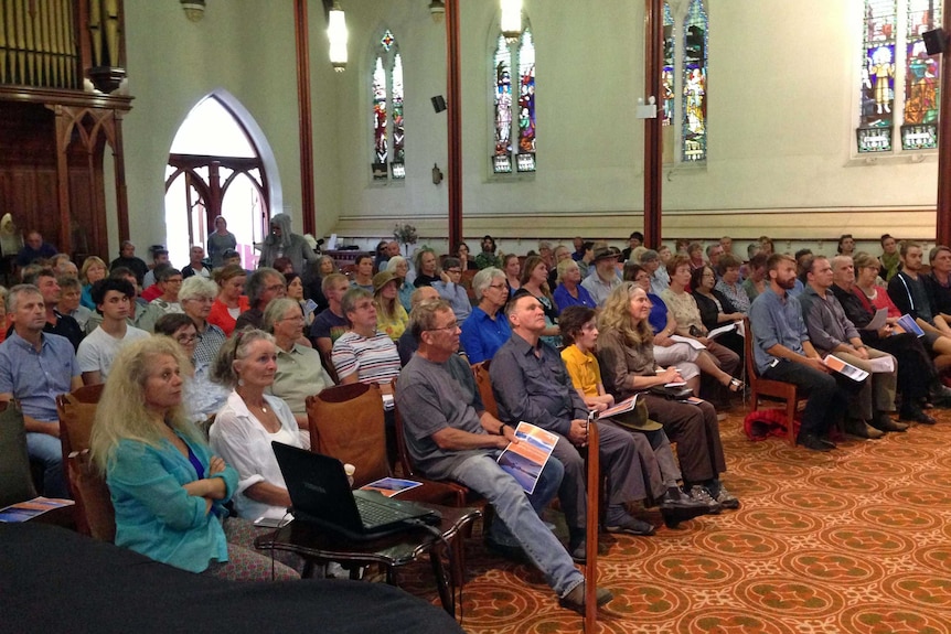 People attend a public meeting in Launceston to protest against opening up national parks to commercial development.