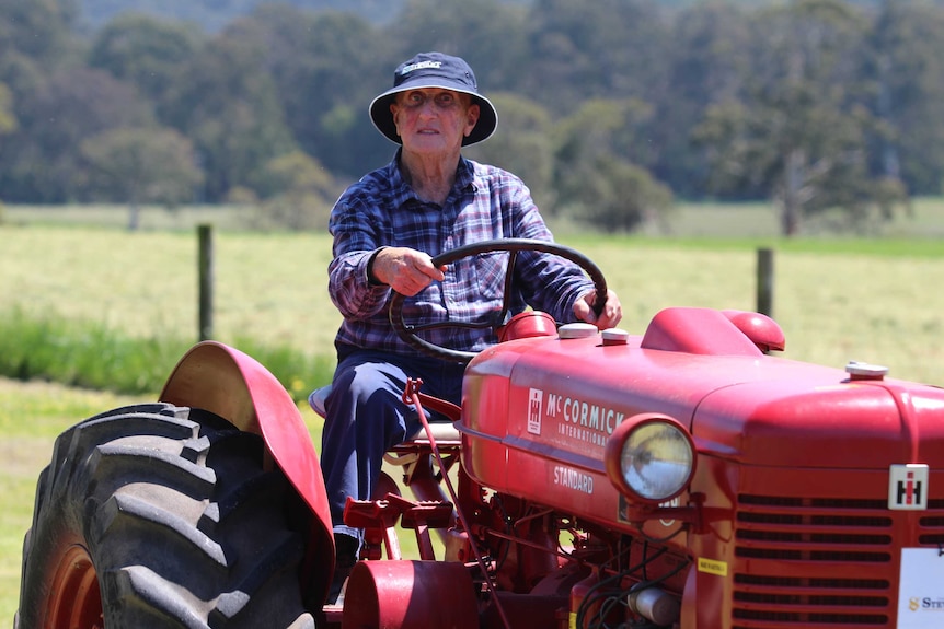 Eric Larson drives one of his antique tractors.
