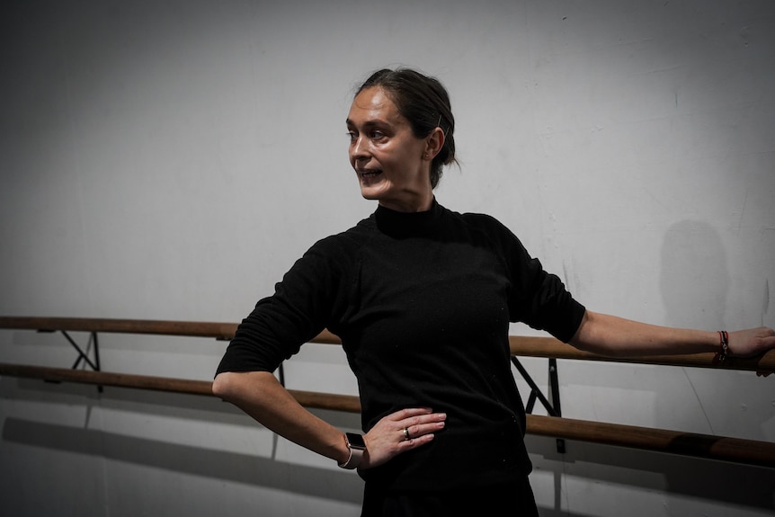 Ukrainian dance teacher Hanna Lazarieva in a black leotard at a dance school.