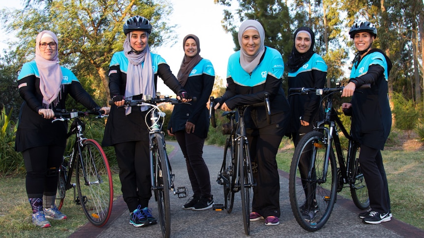 Sydney Cycling Sisters pose in a park with their bikes