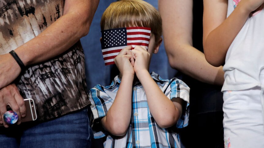 US flag and a little boy