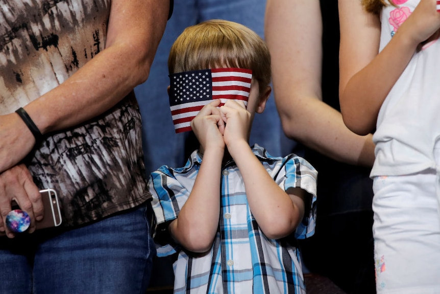 US flag and a little boy