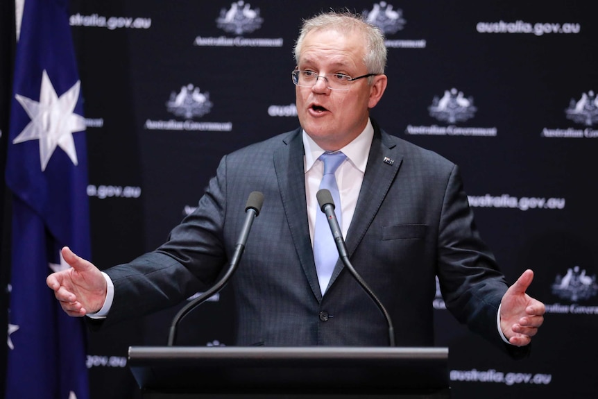 Scott Morrison speaks at a lectern in front of an Australian flag