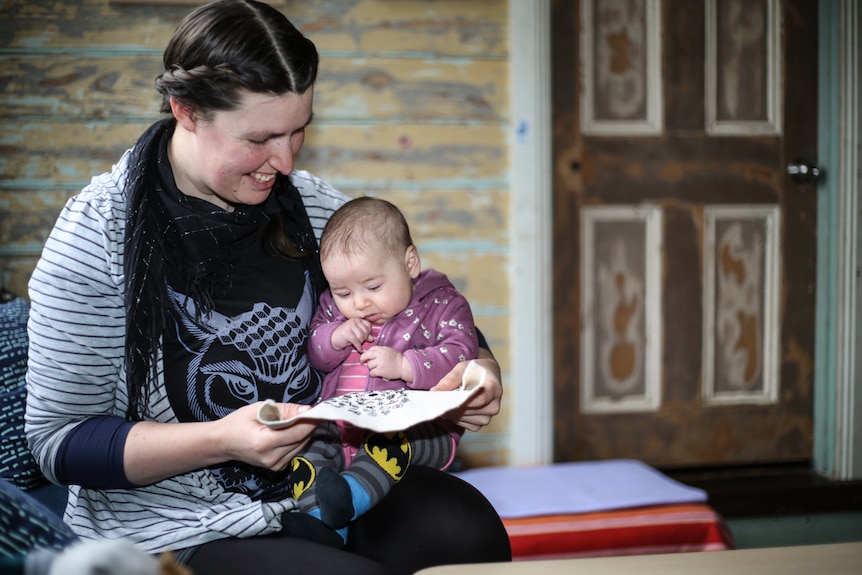 Alice Steel at home with her baby and her winter count