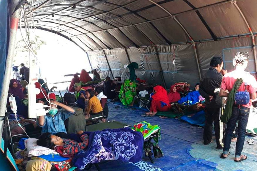 Earthquake survivors receive medical treatment at a temporary shelter
