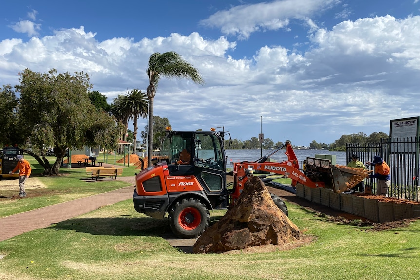 Excavators on the riverbank