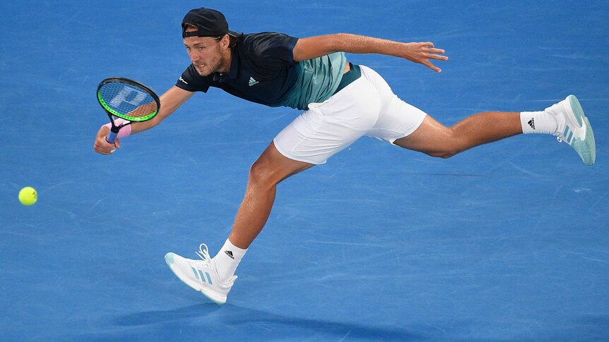A tennis player stretches to hit a forehand on Rod Laver Arena at the Australian Open.