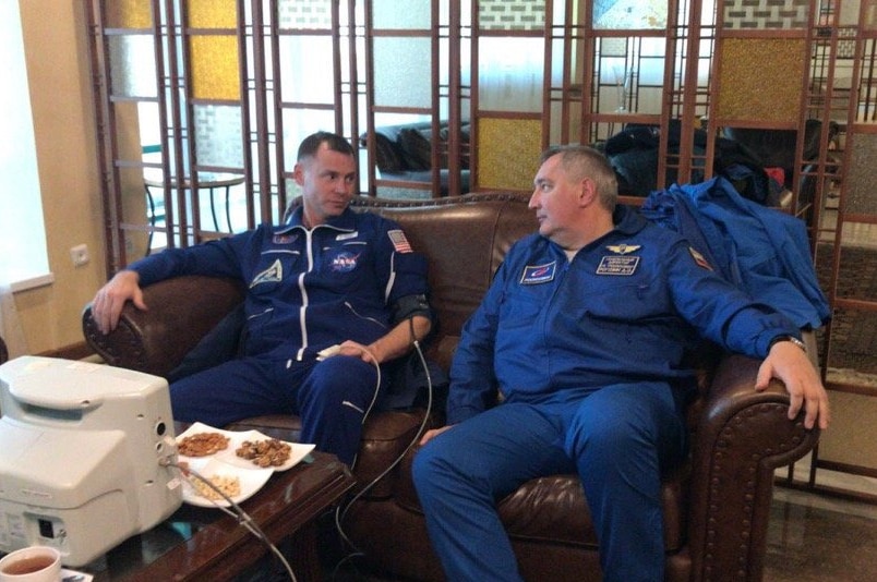 Astronauts Nick Hague and Alexei Ovchinin relax on a sofa as they undergo tests following the rocket emergency landing.