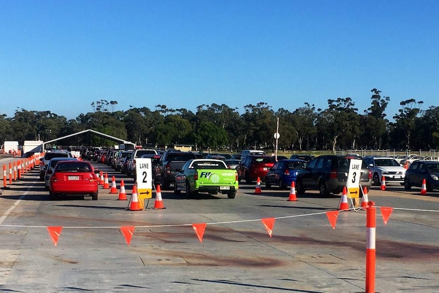 Cars waiting in front of a tent