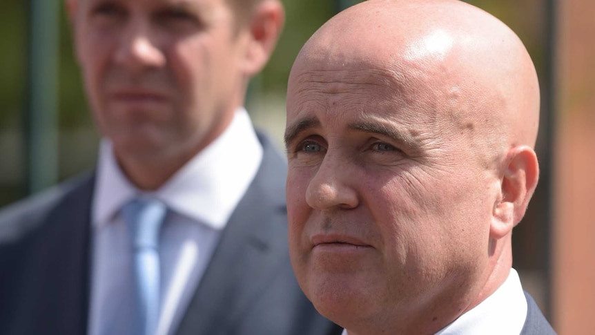 Adrian Piccoli, the NSW Education Minister pictured with Mike Baird visible in the background.