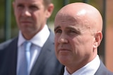 Adrian Piccoli, the NSW Education Minister pictured with Mike Baird visible in the background.
