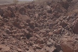 Rubble lies over the site of the Juukan Gorge caves after they were destroyed.