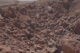 Rubble lies over the site of the Juukan Gorge caves after they were destroyed.