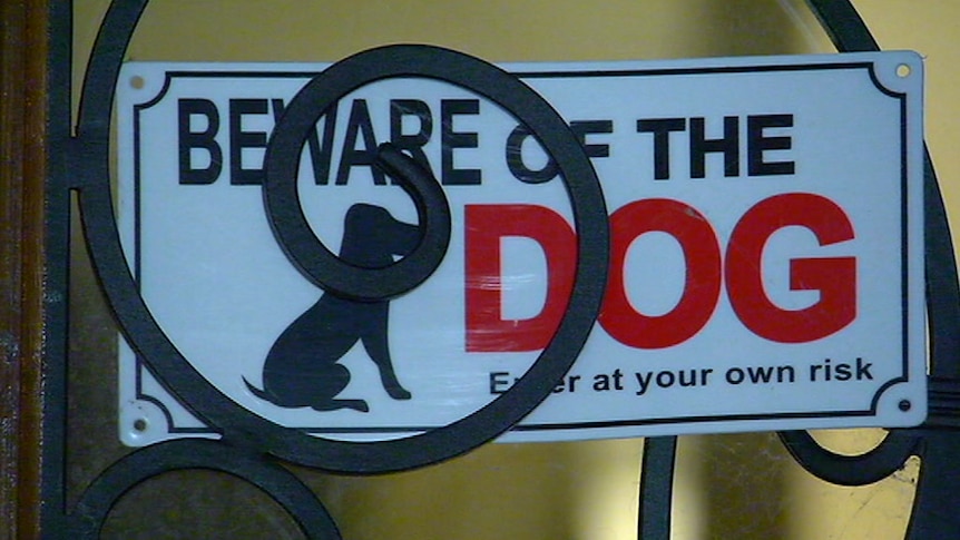 A "beware of the dog" sign on the door of a house