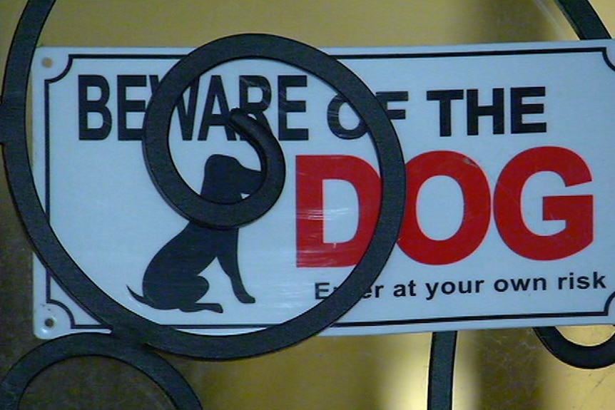 A "beware of the dog" sign on the door of a house