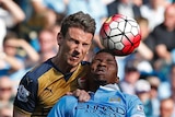 Arsenal's Laurent Koscielny goes for a header with Manchester City's Kelechi Iheanacho in May 2016.