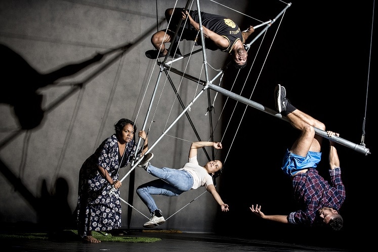 Colour photo of the cast of Man with the Iron Neck posing with Hills Hoist.