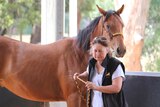 Anne Young with one of the horses that arrived on her property in April 2016.
