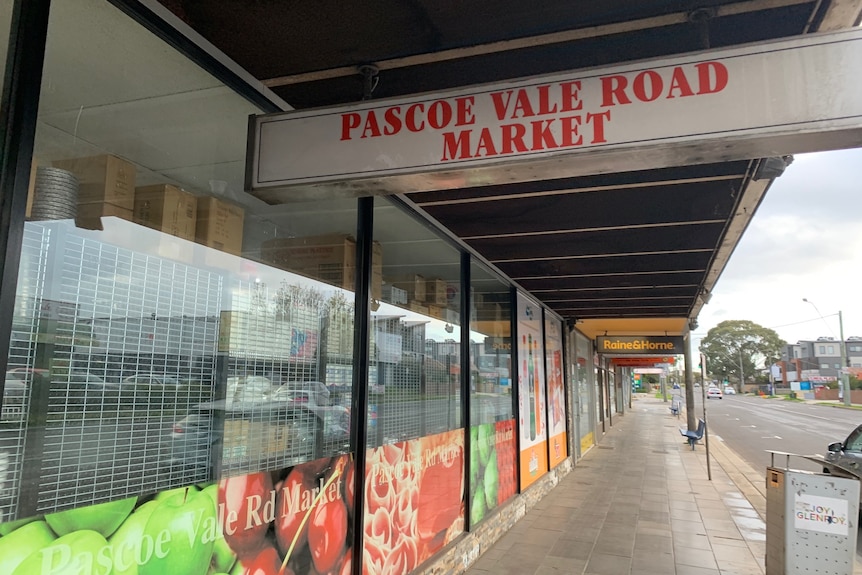 The outside of a closed Pascoe Vale Road Market and the empty suburban footpath.