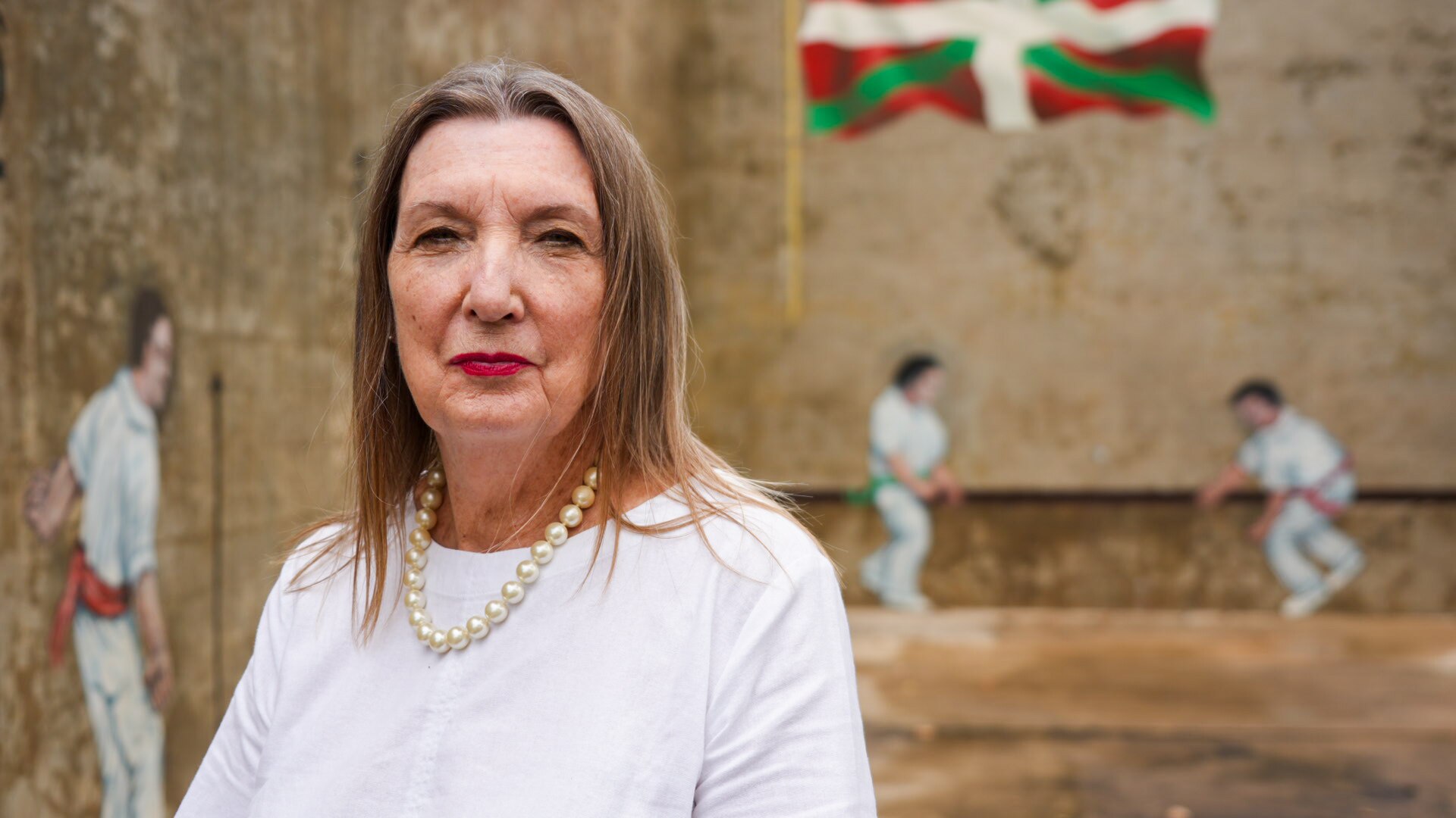 Bianka Vidonja Balanzategui standing in front of a concrete wall.
