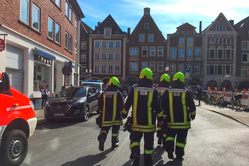 Firefighters are seen walking in downtown Muenster, Germany.