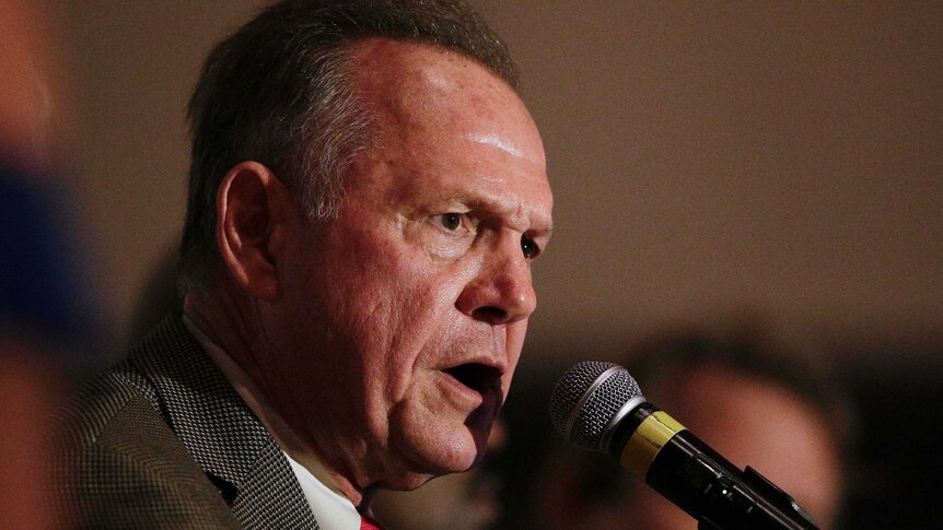 Judge Roy Moore speaks into the microphone at his victory party in Alabama.