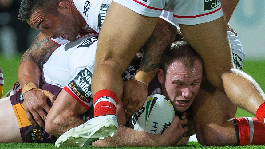 Matt Lodge lies on the ground after being tackled by St George Illawarra players.