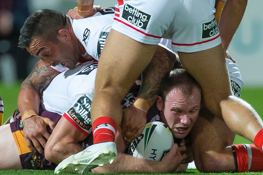 Matt Lodge lies on the ground after being tackled by St George Illawarra players.