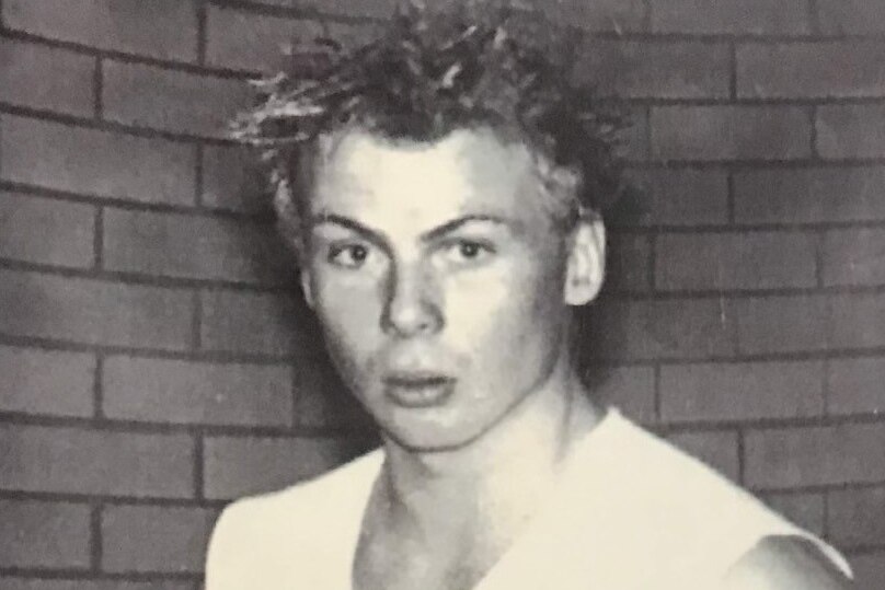 A black and white photo of a teenage boy.