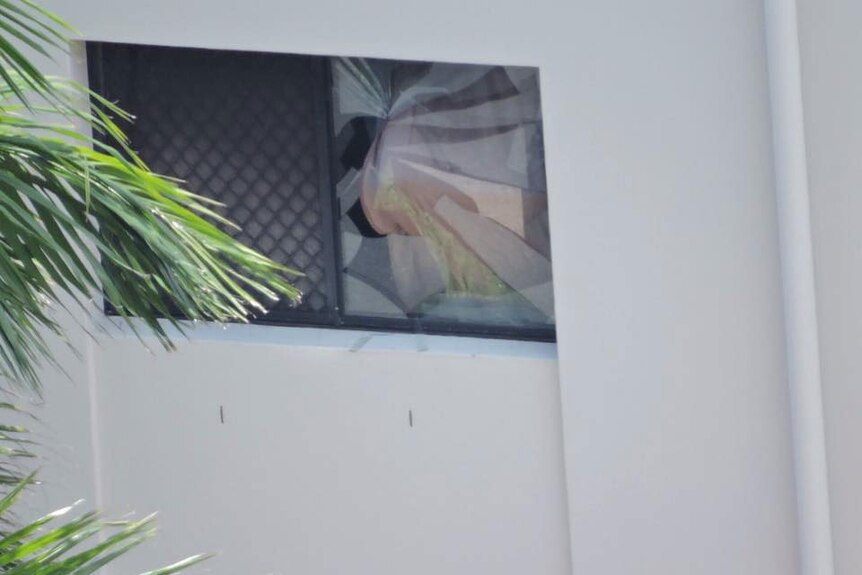 Broken window of Gold Coast unit that looks like a gunshot on December 25, 2014