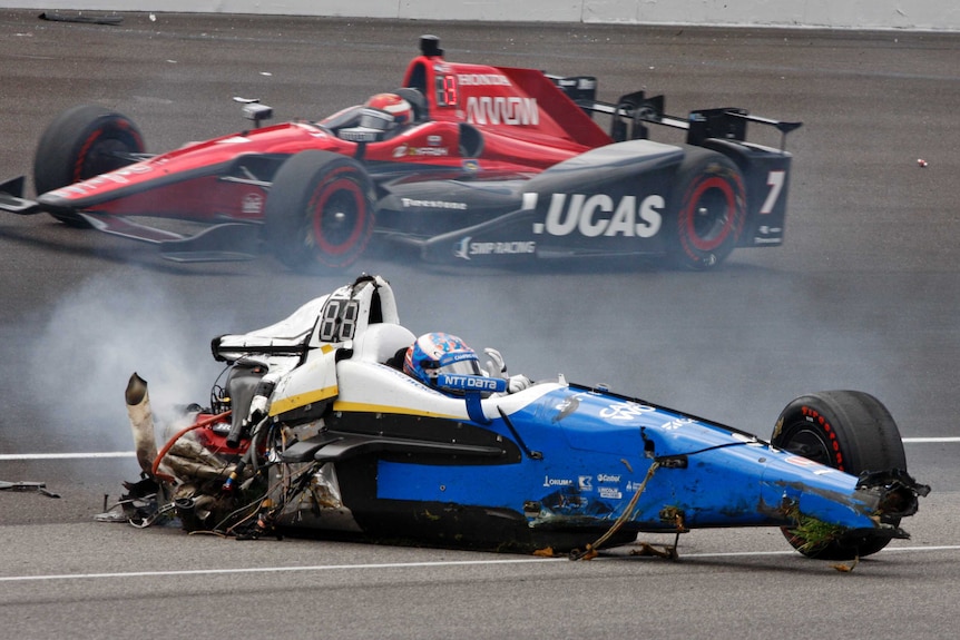 Scott Dixon's mangled car is stopped on the track at Indy.